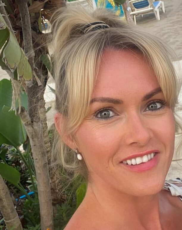 Shanine from Shanine's Nails and Beauty, smiling, with her blonde hair pinned up