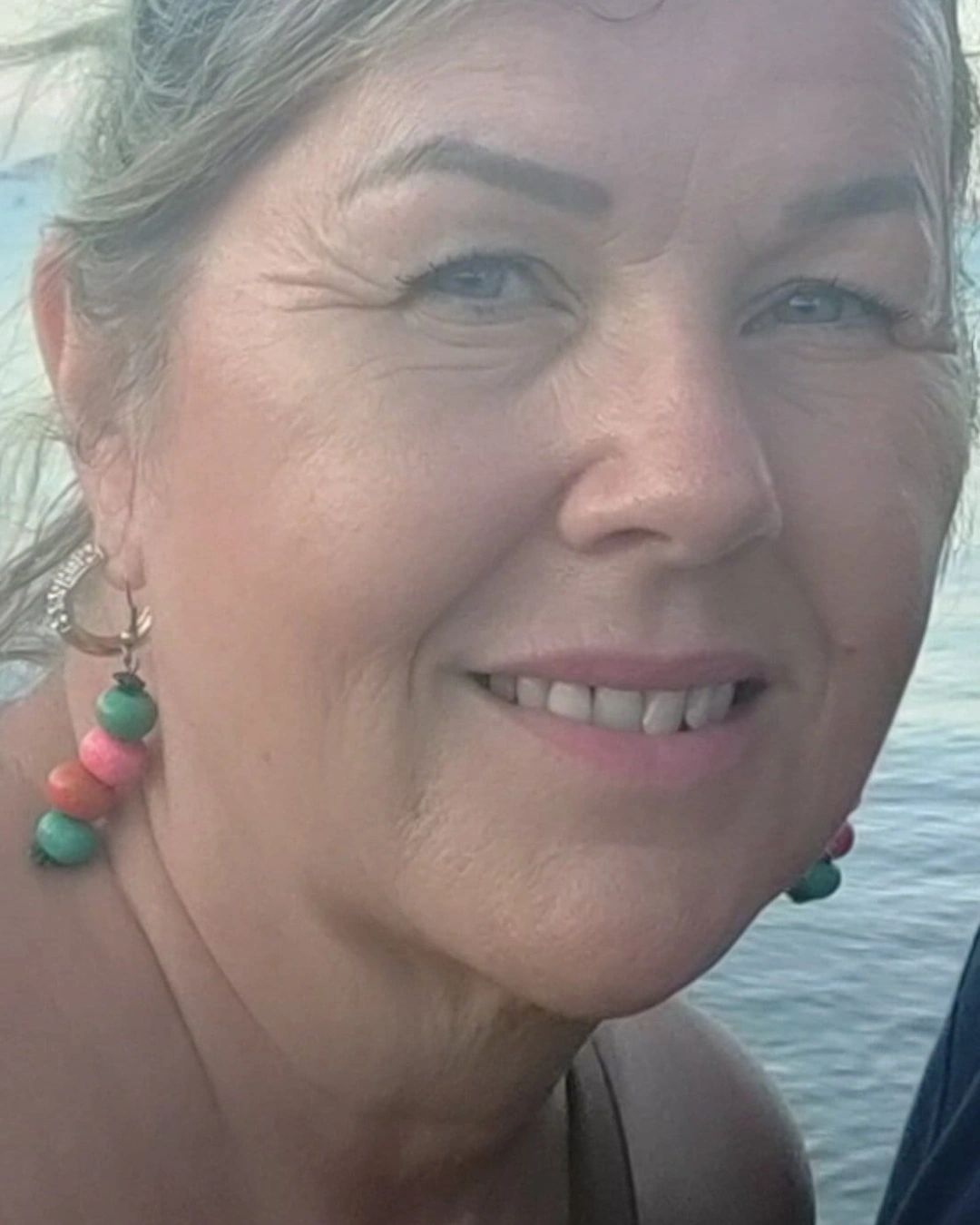 Tracy Ede smiling by the sea